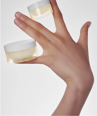 cosmetics containers in hand